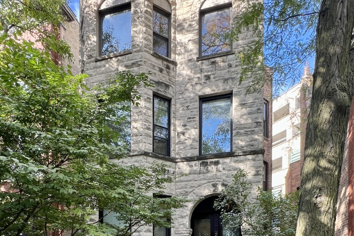3 story greystone building in Lincoln Park with clear skies