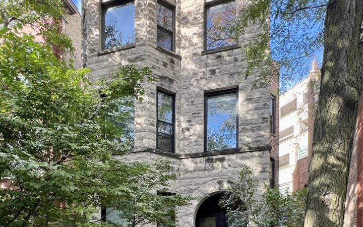 3 story greystone building in Lincoln Park with clear skies